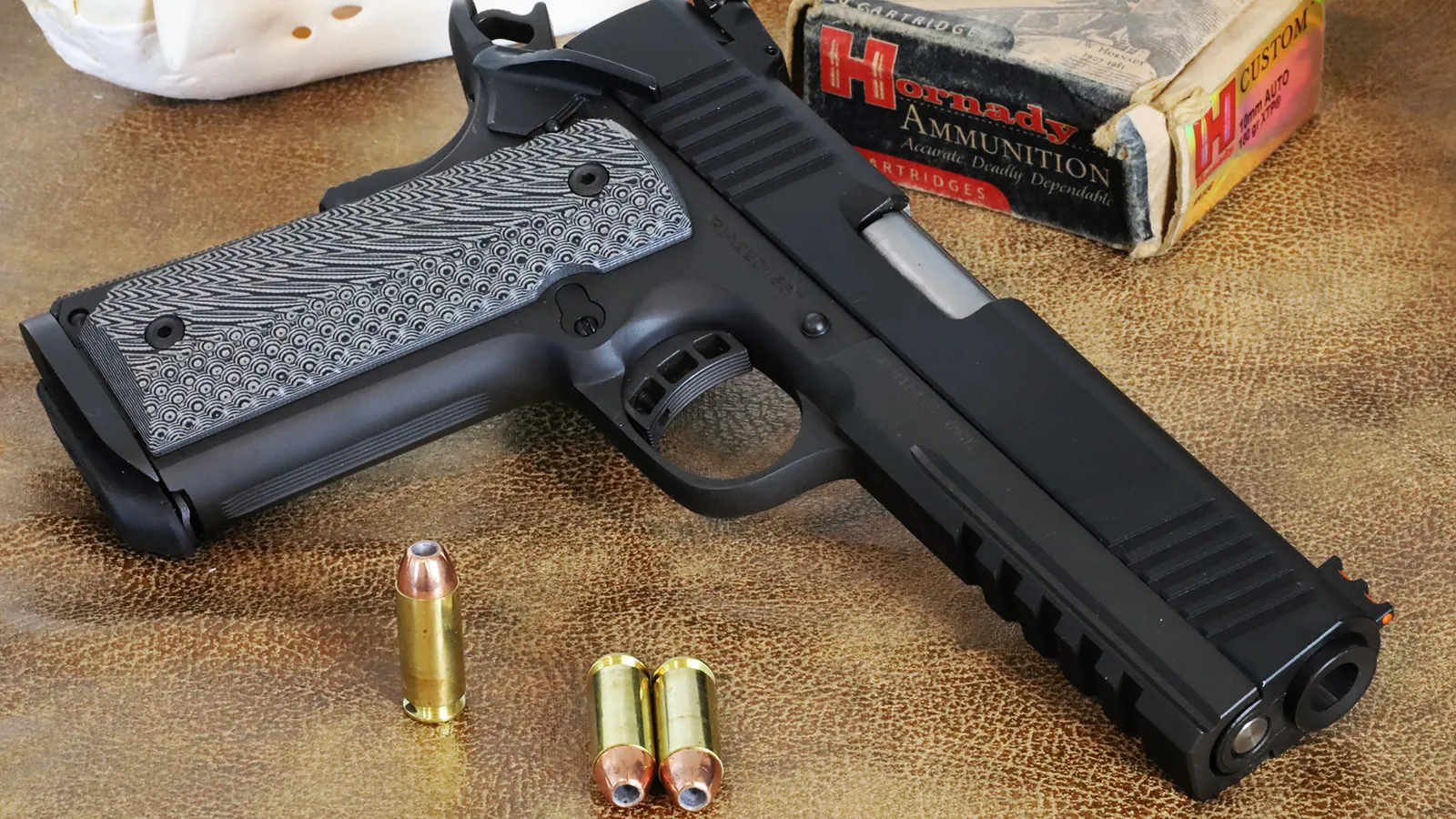10mm pistol and ammunition on a rock in bear country