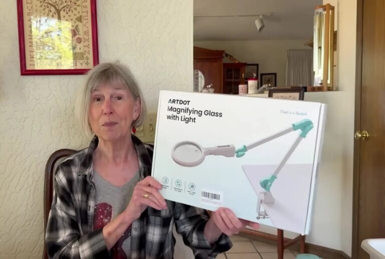 A modern magnifying lamp with stand provides clear illumination for a delicate craft project.