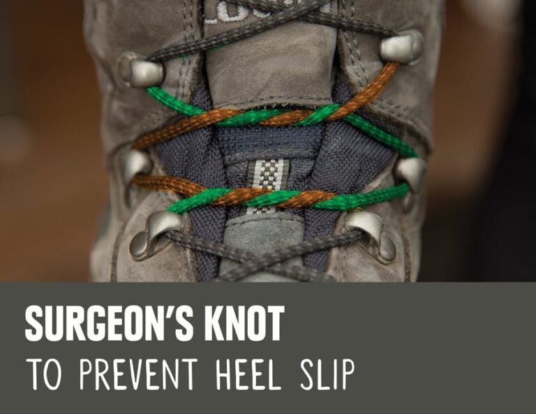 Sturdy hiking boots with durable red laces resting on a rocky mountain trail.
