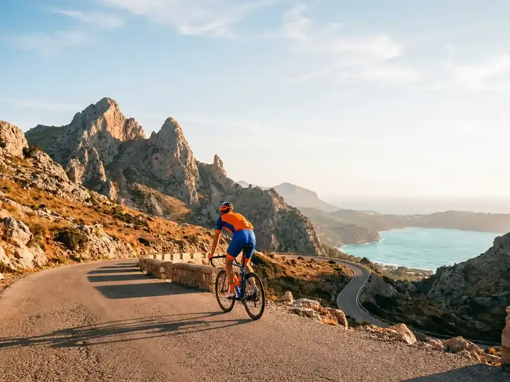 Travellers with a bike and hiking boots in a bright Alcúdia hotel room