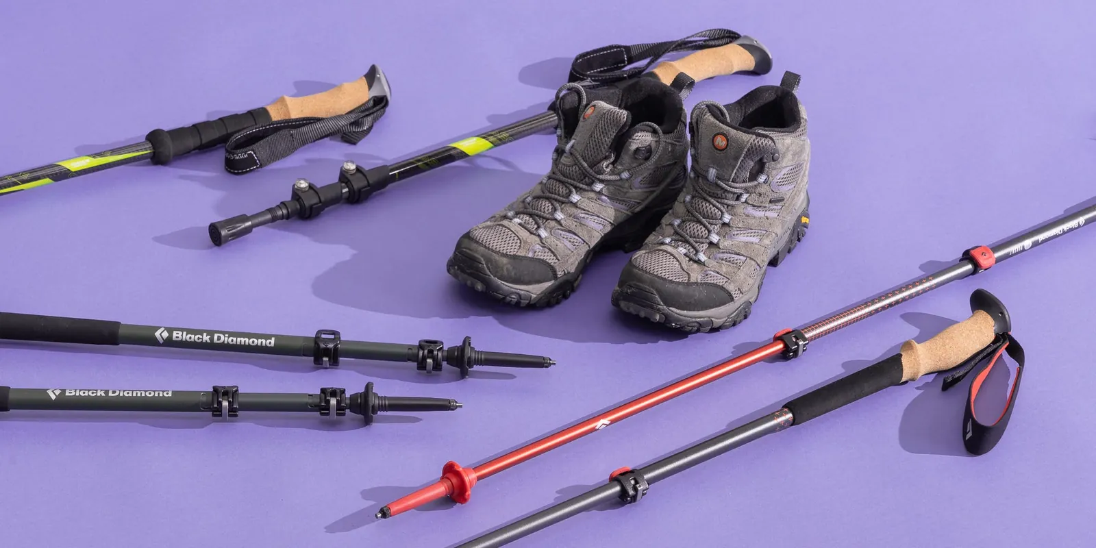 Two hiking poles set to noticeably different lengths on a rock
